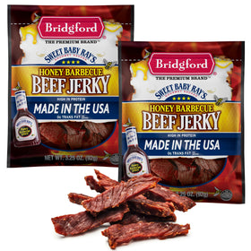 Bridgford Sweet Baby Ray's beef jerky with honey BBQ, close-up glossy glaze.