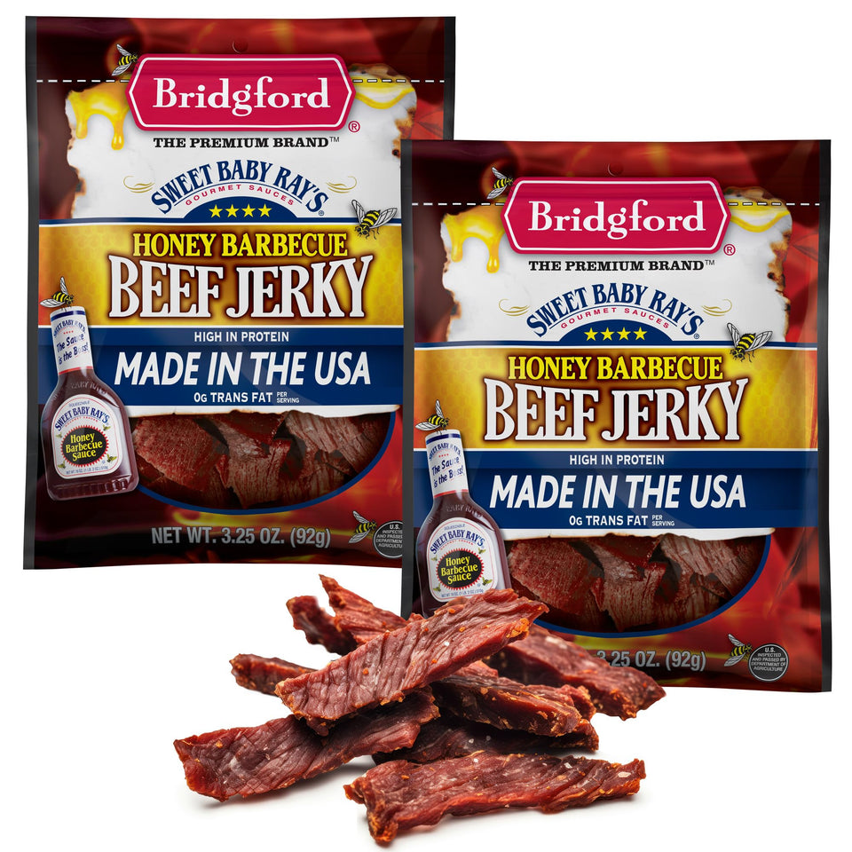 Bridgford Sweet Baby Ray's beef jerky with honey BBQ, close-up glossy glaze.