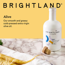 Brightland Alive bottle in pour shot, perfect for drizzling hummus.