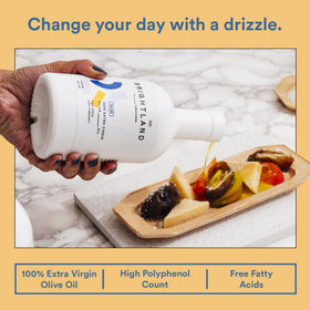 Awake bottle beside steaming soups and stews in a cozy kitchen.