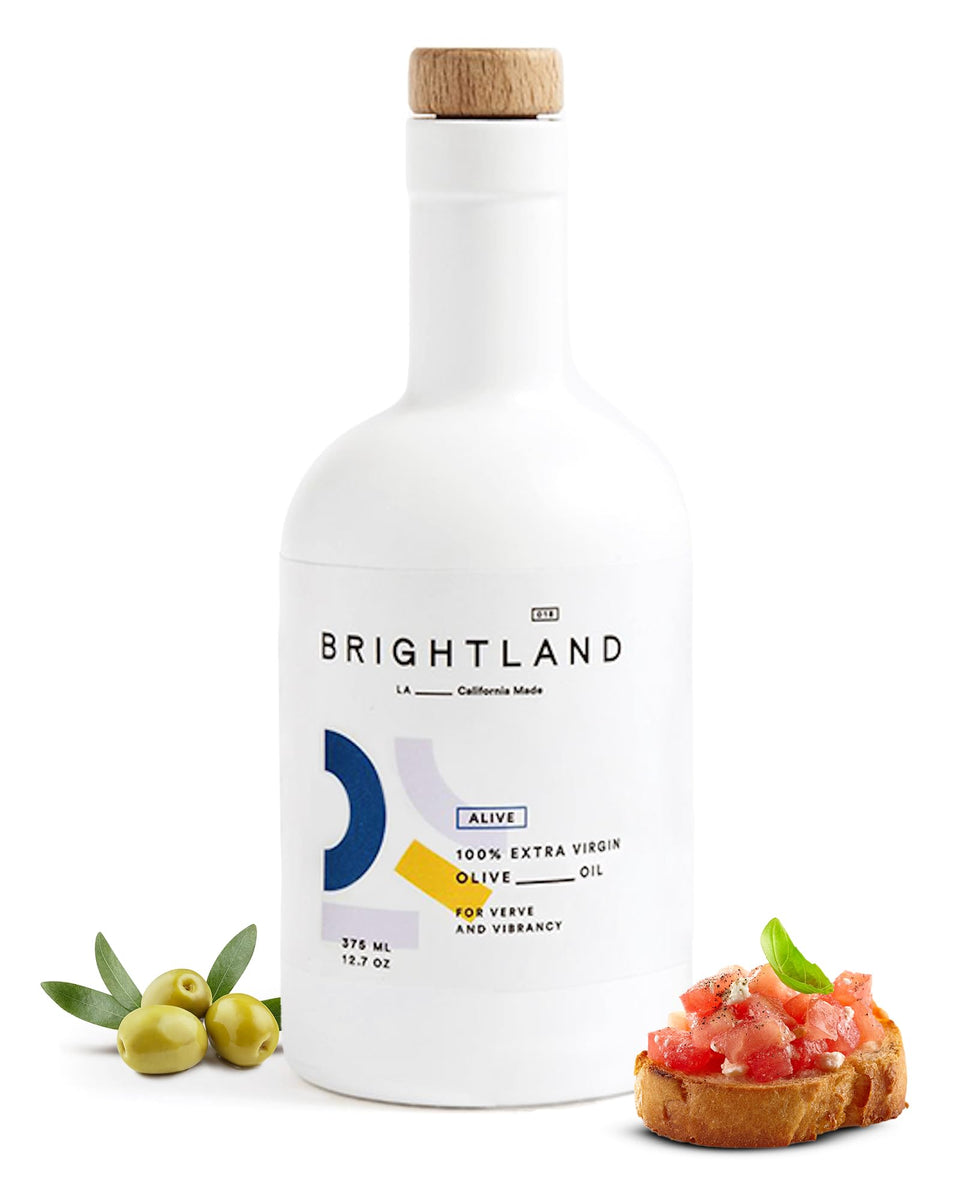 Brightland Alive olive oil bottle with golden hue, ideal for fresh salads.