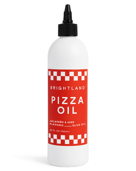 Brightland Pizza Oil bottle on a kitchen counter, ready to elevate sauces and pizzas.