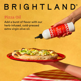 Brightland Pizza Oil drizzle atop a hot slice, showcasing herbaceous warmth.