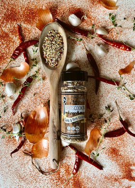 Britscookin Garlic and Herb seasoning bottle angled for weeknight proteins.