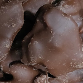 Milk chocolate coating on crisp Brittle Brothers brittle nuggets.