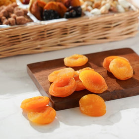Broadway Basketeers fruit assortment on a gift tray signals thoughtful condolence.