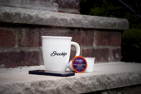 Close-up of Brooklyn Beans Decaf pod highlighting deep roast notes and aroma.