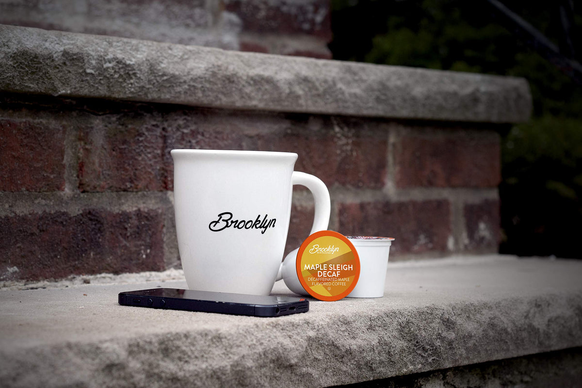 A steaming cup poured from a Maple Sleigh Decaf pod brew.