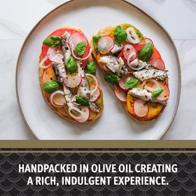 Brunswick sardines plated on greens or toast with olive oil drizzle.