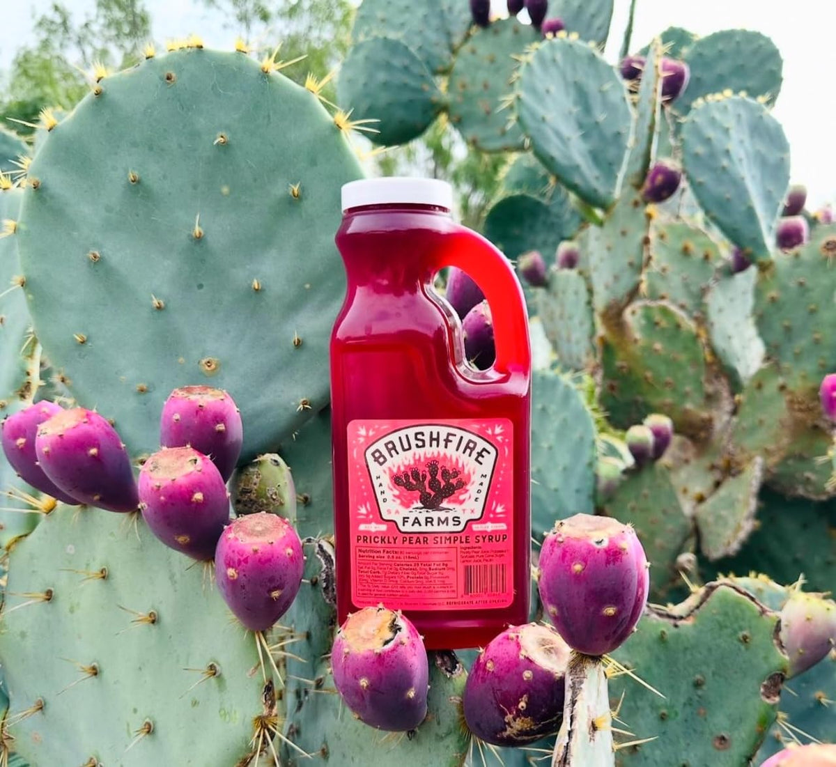 Brushfire Farms Prickly Pear Syrup being poured, perfect for margaritas and mocktails.
