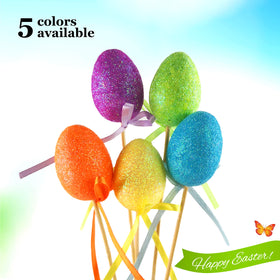 Bstaofy eggs planted in soil add color to garden borders.