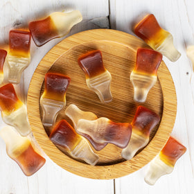Close-up of cola gummy bottles in a bowl for candy jars and gifting.