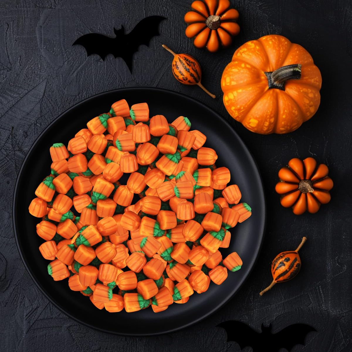 Colorful pumpkins on a candy buffet enhance Halloween party décor