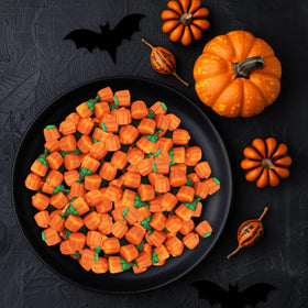 Colorful pumpkins on a candy buffet enhance Halloween party décor