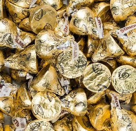 Buha Sweets party candy bowl with gold-wrapped kisses for festive gatherings.