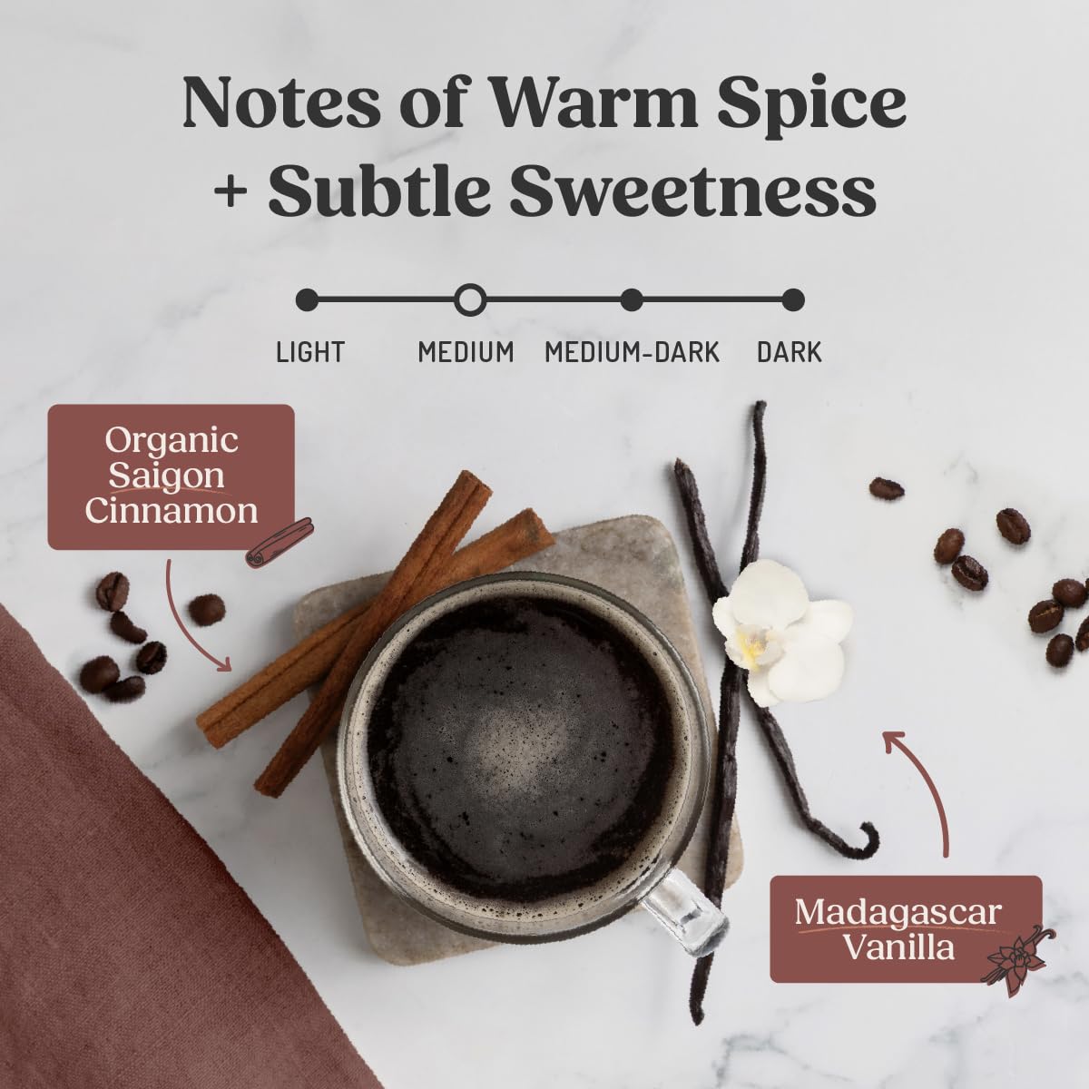 Steaming cup of Bulletproof Cinnamon & Vanilla coffee on a desk