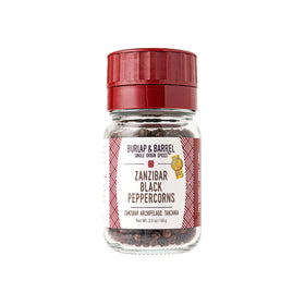 Burlap & Barrel Zanzibar black peppercorns in a jar for fresh grinding and bright flavor.