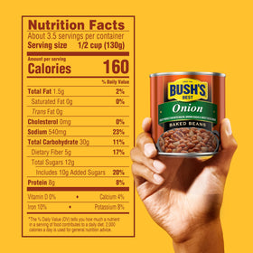 Serving bowl of Bush's Best Onion Baked Beans beside grilled burgers.