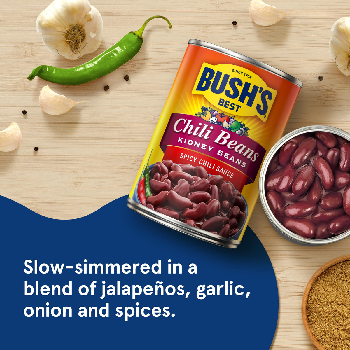 Bush's Best spicy dark red chili beans in a serving bowl with sauce.