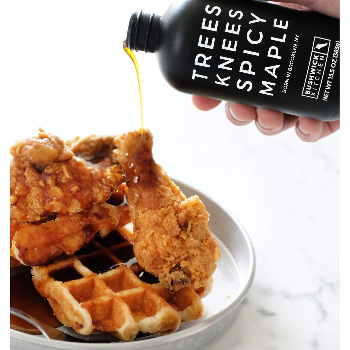 Bushwick Kitchen Trees Knees Syrup poured over fluffy pancakes for bold flavor
