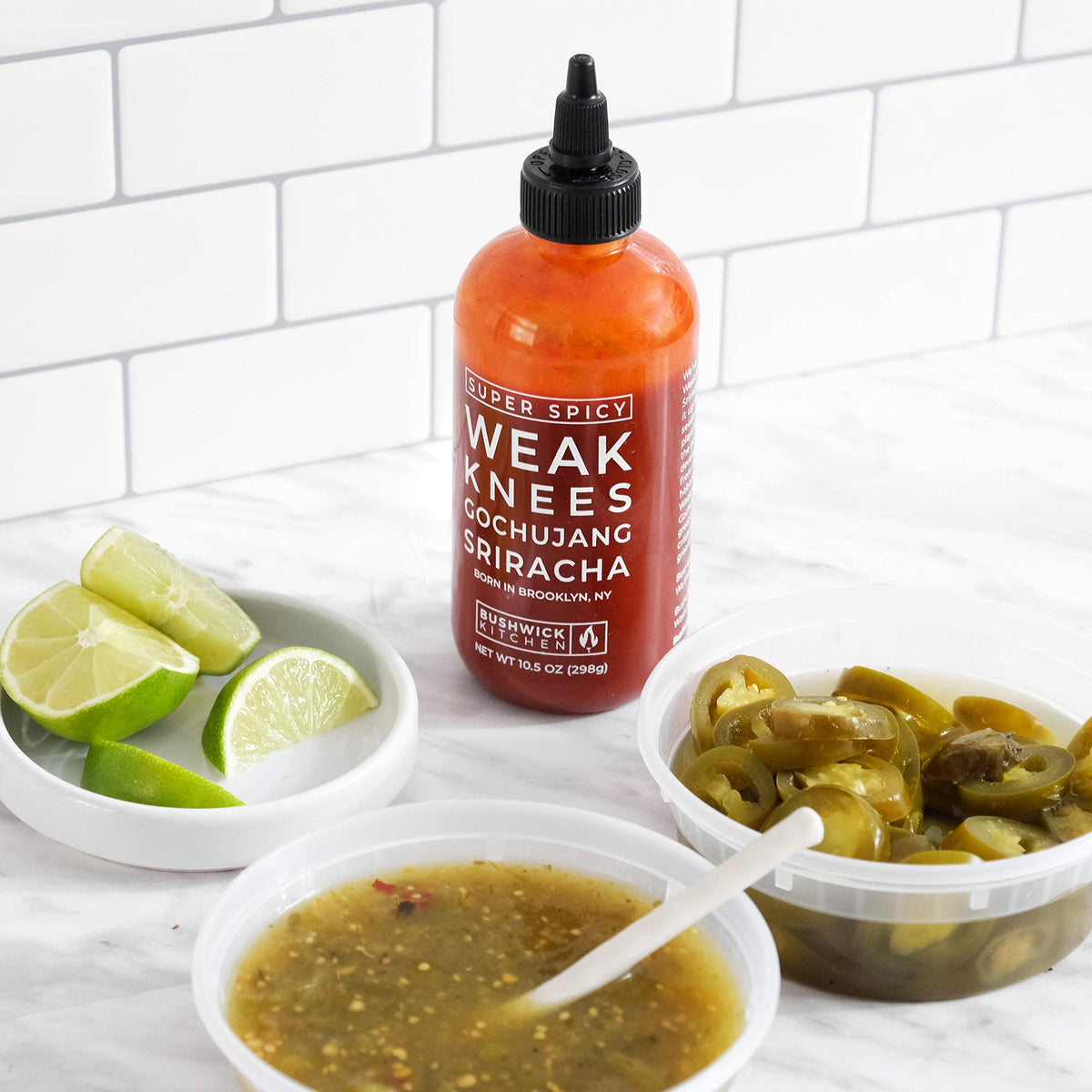 Grocery shelf display of Bushwick Kitchen Weak Knees gochujang-sriracha sauce