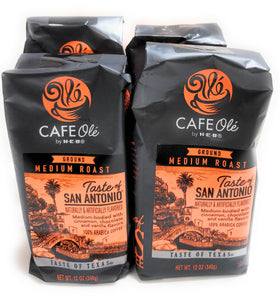 Cafe Ole ground coffee ready to brew beside a cup and steam.