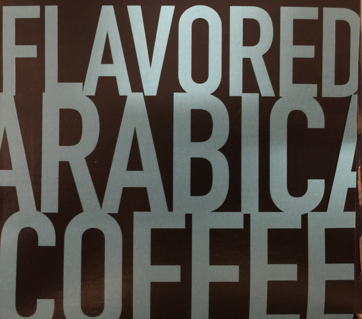 Cafe Olé Snickernut ground coffee close-up emphasizes premium Arabica.