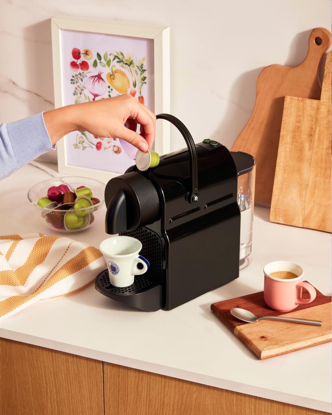 Capsules in use with a Nespresso Original machine for consistent extraction.