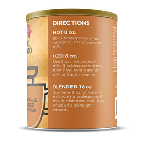 A glass of frothy caramel latte made with instant mix.