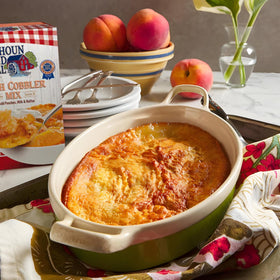 Calhoun Bend Mill Peach Cobbler bubbling in a dish during baking.