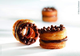 Cookie dough with Callebaut 70% callets showing rich pockets of chocolate.