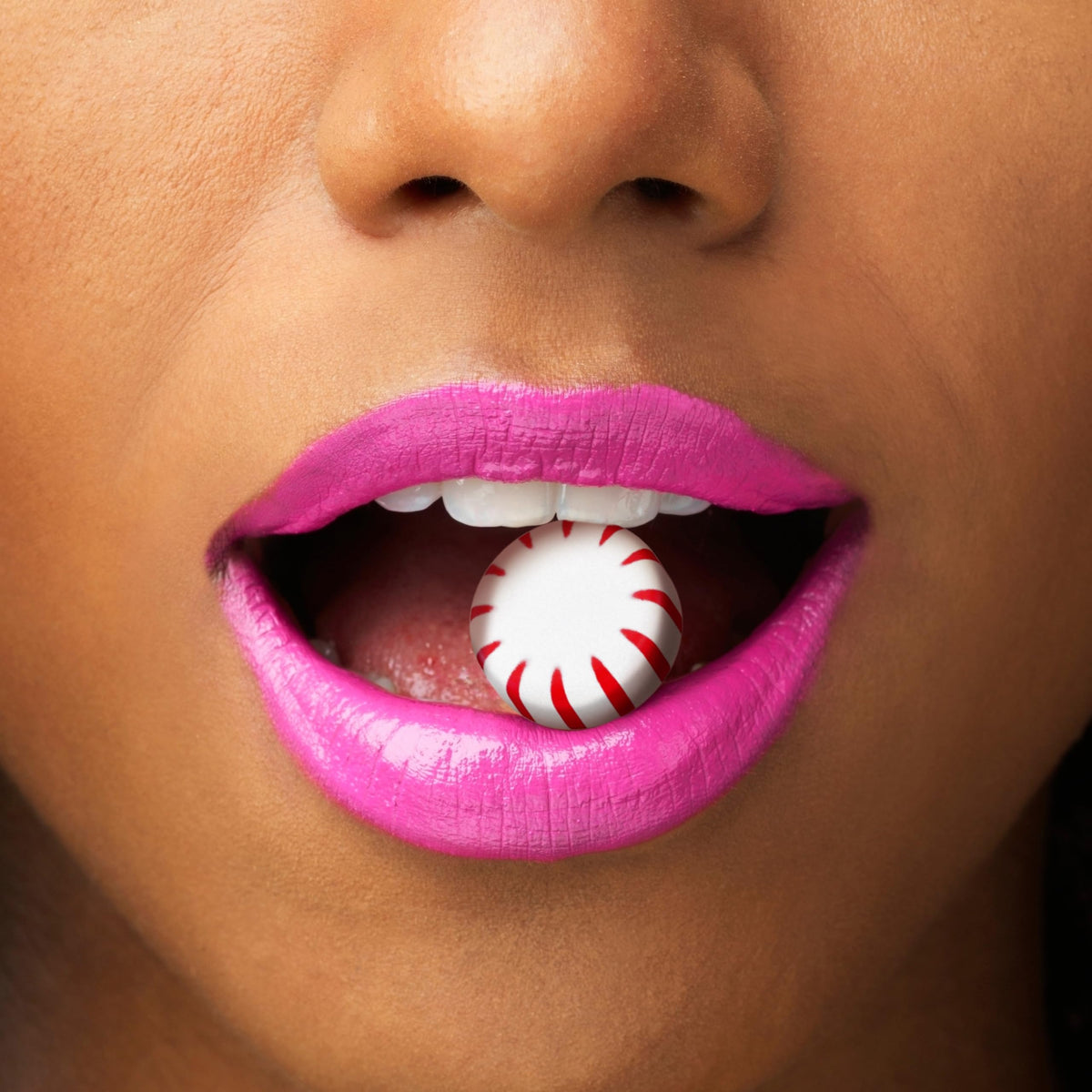 Cambie sugar-free peppermint wrapped candy with a glass of water for breath-freshening use
