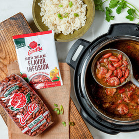 Beans and rice plated with Camellia flavor infusion.