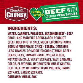 Campbells Chunky Beef Soup staged near a campfire for outdoor meal idea.