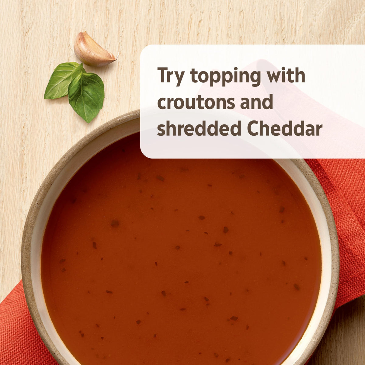 Soup topped with croutons and Cheddar on Campbell’s Homestyle Tomato Basil Soup.