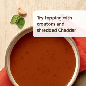 Soup topped with croutons and Cheddar on Campbell’s Homestyle Tomato Basil Soup.