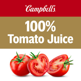 Glass with ice and lime beside Campbell's tomato juice for a refreshing mocktail.