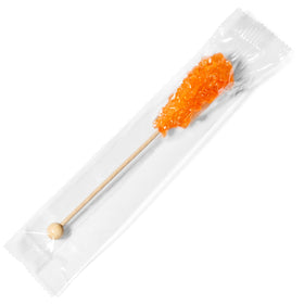 Candy Envy orange café sugar stick beside a mug for quick sweetness