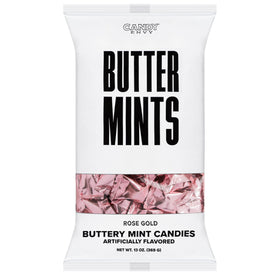 Candy Envy buttermints on a table with rose gold wrappers visible.