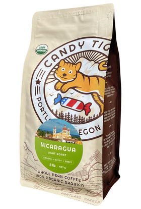 Candy Tiger Portland whole bean coffee showcases organic beans for a vibrant aroma.