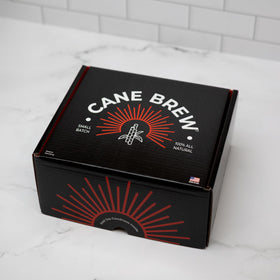 Cane Brew wooden spoon beside cups for effortless stirring and serving