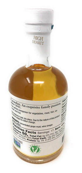 Pouring Carandini Bianca Sweet White Vinegar into a crisp salad dressing.