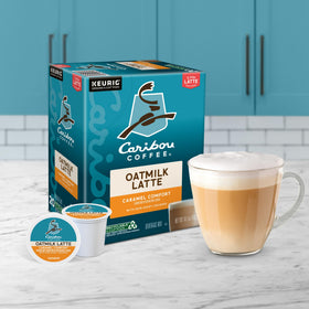 Caribou Coffee logo on packaging beside a cozy mug.