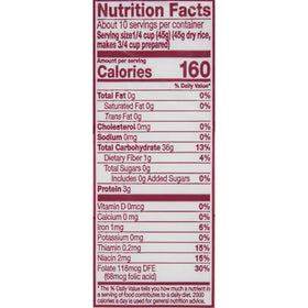 Measuring cup with dry Carolina Enriched Rice for portions