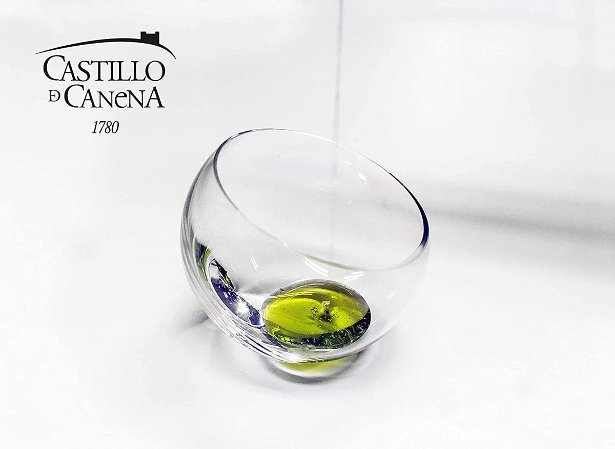 Castillo de Canena Picual olive oil on glass with spoon suggests fresh aroma and versatility.