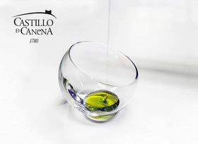 Castillo de Canena Picual olive oil on glass with spoon suggests fresh aroma and versatility.