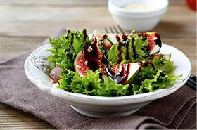 Castillo De Pinar citrus balsamic drizzle over tomato basil cheese salad.