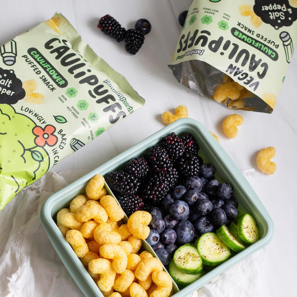 CauliPuffs lunchbox snack idea shown with a portable bag.
