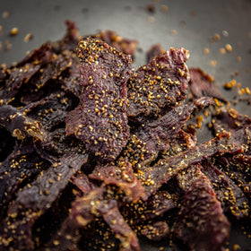 Centennial Cuts Beef Jerky Cowboy Style close-up of protein-packed texture for post-workout snacking.