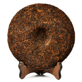 ChaWuWarmSun JinYaGongTing tea cake in hot water cup, mellow comfort after meals.